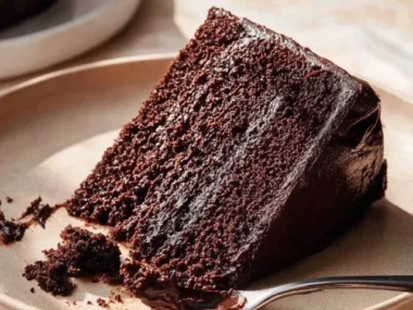 Deliciously rich Chocolate Espresso Cake topped with chocolate ganache and coffee beans.