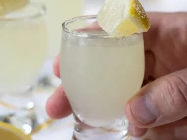 Classic lemon drop shot cocktail served in a glass with a lemon slice