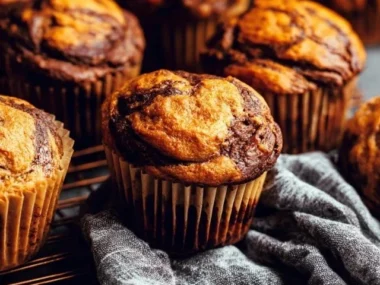 Chocolate marble pumpkin muffins baked to perfection, perfect for fall treats.
