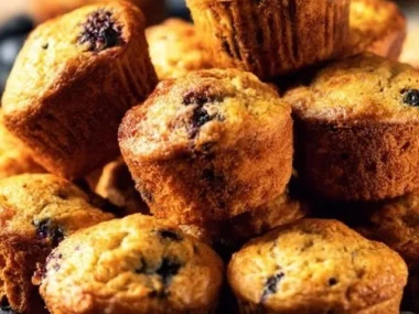 Mini blueberry muffins baked to perfection, served fresh and fluffy.
