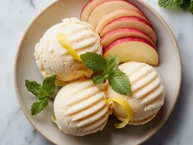 Delicious homemade apple sorbet served in a bowl with fresh apple slices.