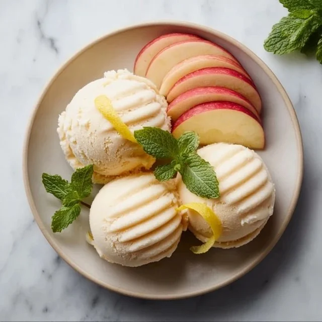 Delicious homemade apple sorbet served in a bowl with fresh apple slices.