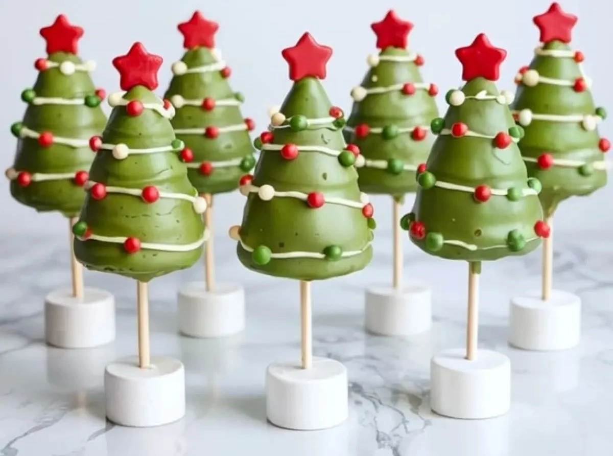 Festive Christmas Tree Cake Pops decorated with green icing and colorful sprinkles