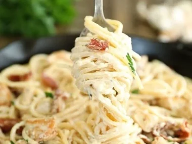 Cream Cheese Bacon Chicken Pasta dish garnished with herbs