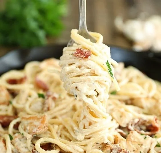 Cream Cheese Bacon Chicken Pasta dish garnished with herbs
