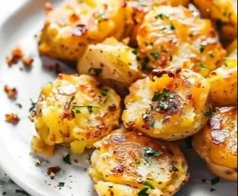 Delicious crispy garlic smashed potatoes served with herbs