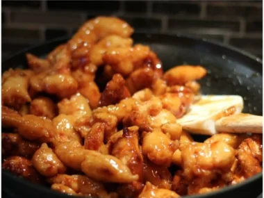 Plate of Honey Sesame Chicken with garnishes and sesame seeds