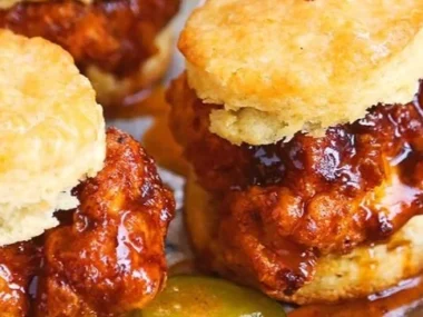 Hot Honey Chicken Biscuits served on a rustic plate with a spicy honey drizzle.