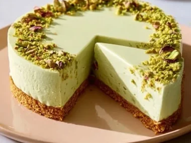 No-bake pistachio cheesecake slice with whipped cream and pistachio garnish