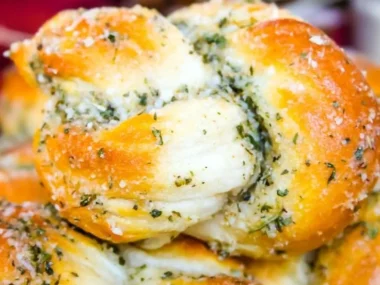 Freshly baked Parmesan Garlic Knots topped with garlic and herbs