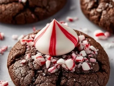 Peppermint chocolate blossom cookies topped with festive candy cane pieces.
