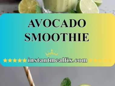 Creamy avocado smoothie in a glass topped with fresh mint leaves