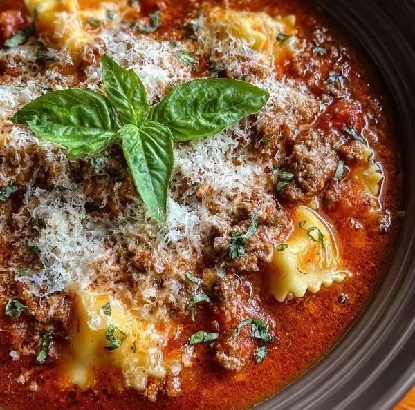 A bowl of delicious Crock Pot Lasagna Soup garnished with herbs.