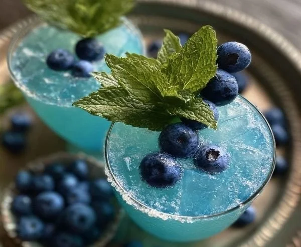 A refreshing Jack Frost Mimosa cocktail garnished with seasonal fruits.