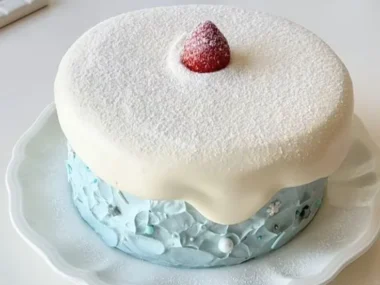 Merry Christmas Lava Angel Cake with festive decorations and snow theme.