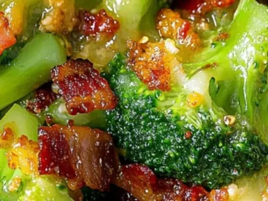 Savory broccoli with garlic sauce and crispy bacon on a white plate