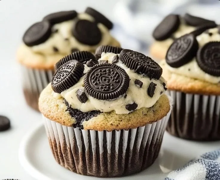 Bakery-style Oreo muffins with chocolate chunks and creamy filling
