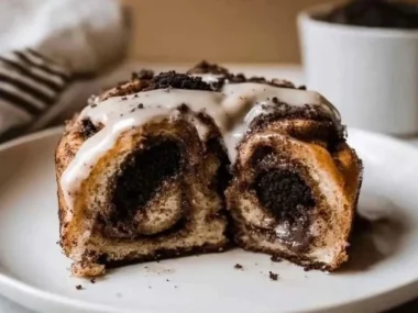 Gooey cinnamon rolls topped with crushed Oreos for a delicious dessert.