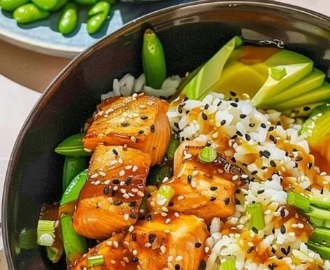 Honey Butter Roasted Salmon Rice Bowl topped with fresh herbs and vegetables