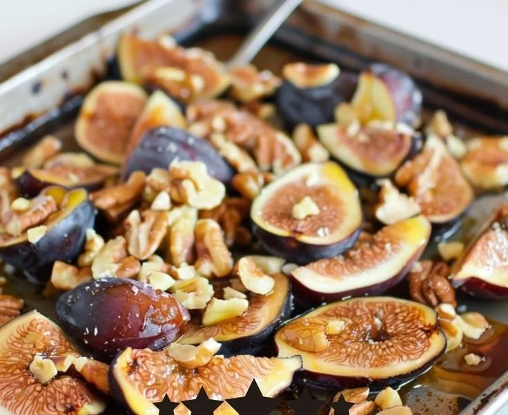 Delicious honey-roasted walnuts and figs presented on a wooden board.