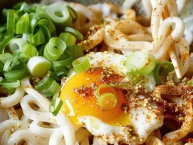 Delicious Kimchi Butter Udon topped with a soft boiled egg for a perfect meal.