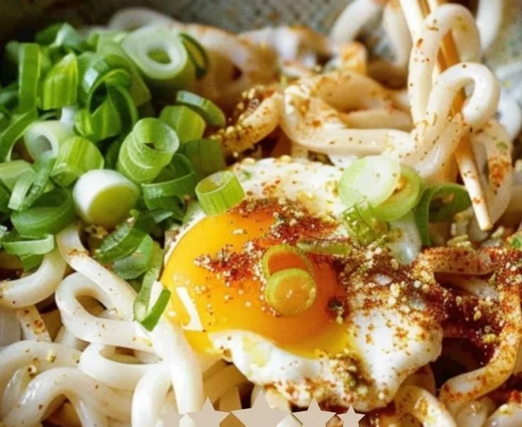 Delicious Kimchi Butter Udon topped with a soft boiled egg for a perfect meal.