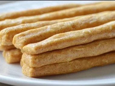 Dog enjoying Banana Peanut Butter Chew Sticks, a healthy pet treat