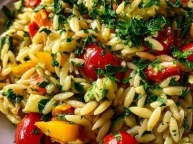 Delicious orzo dinner served with fresh vegetables and herbs