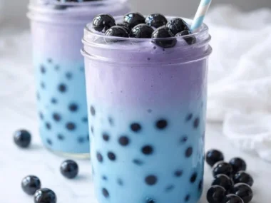 A vibrant Butterfly Blue Boba Tea with tapioca pearls and colorful butterfly pea flower.