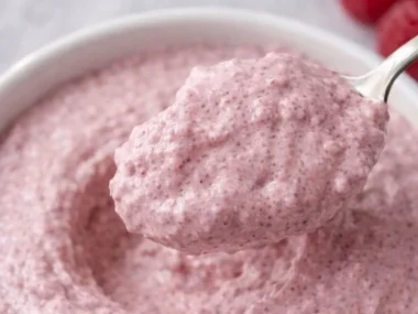 Healthy raspberry chia seed pudding served in a bowl with fresh berries