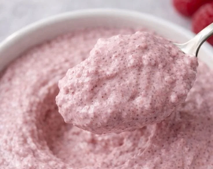 Healthy raspberry chia seed pudding served in a bowl with fresh berries
