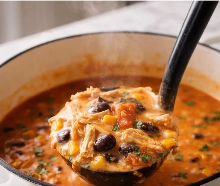 Bowl of easy chicken tortilla soup garnished with tortilla strips and avocado