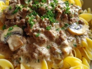 Plate of Easy Ground Beef Stroganoff served with noodles and garnished with parsley