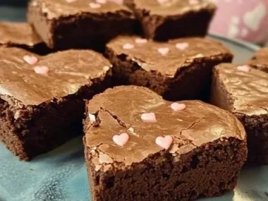 Heart-shaped fudge brownies with a rich chocolate texture on a decorative plate