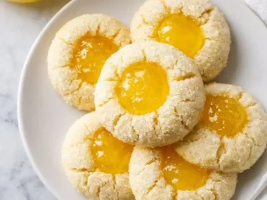 Homemade lemon curd thumbprint cookies on a plate