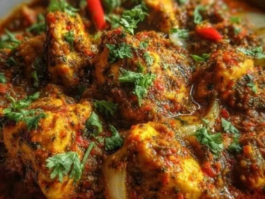 Delicious Indian Chicken Curry served with rice and garnished with cilantro.