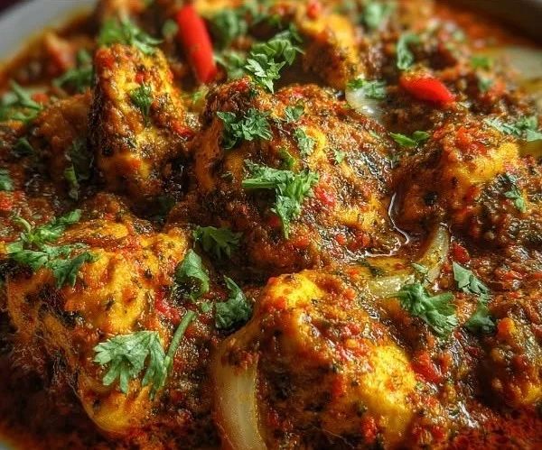 Delicious Indian Chicken Curry served with rice and garnished with cilantro.