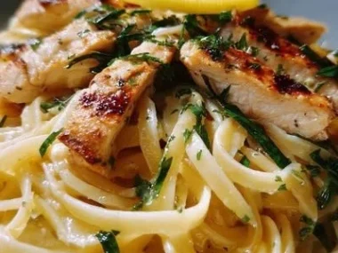 A plate of Lemon Chicken Pasta garnished with fresh herbs and lemon zest.