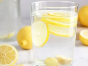 A refreshing glass of lemon ginger water with fresh ingredients.