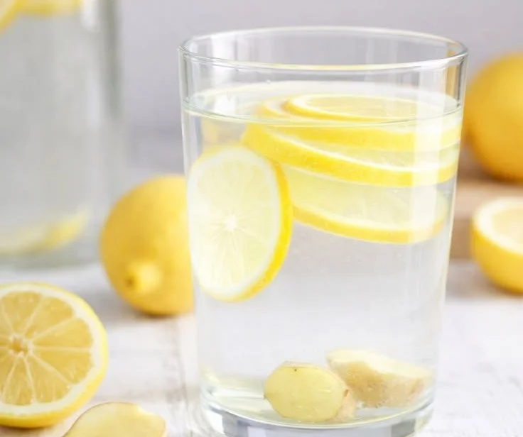A refreshing glass of lemon ginger water with fresh ingredients.