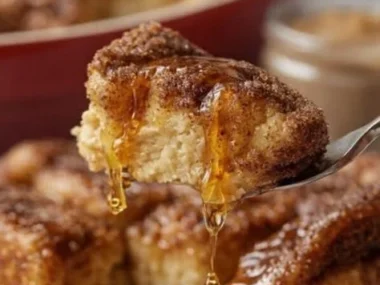 Delicious Overnight French Toast Bake topped with syrup and fresh fruit