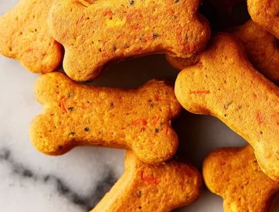 Homemade pumpkin and carrot dog cookies fresh on a plate