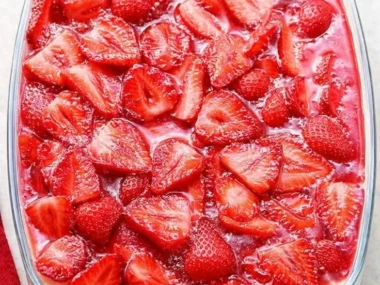 No-bake Strawberry Heaven Cake topped with fresh strawberries and whipped cream