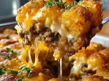 Delicious Tater Tot Casserole served in a dish with golden crispy tops.