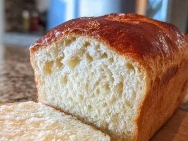 Freshly baked zero-carb yogurt bread on a wooden board.