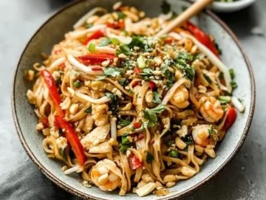 Delicious plate of authentic Pad Thai with shrimp, peanuts, and lime