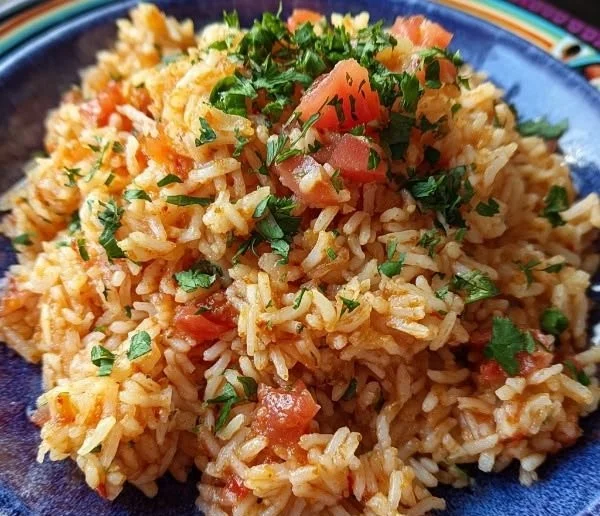 Bowl of authentic spicy fluffy Mexican rice garnished with cilantro