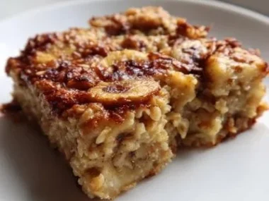 Homemade banana oatmeal bars stacked on a wooden table