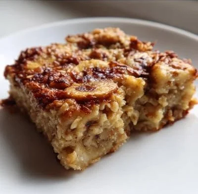 Homemade banana oatmeal bars stacked on a wooden table