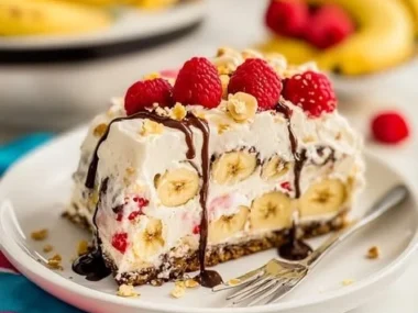 Delicious Banana Split Cake layered with bananas, whipped cream, and chocolate sauce